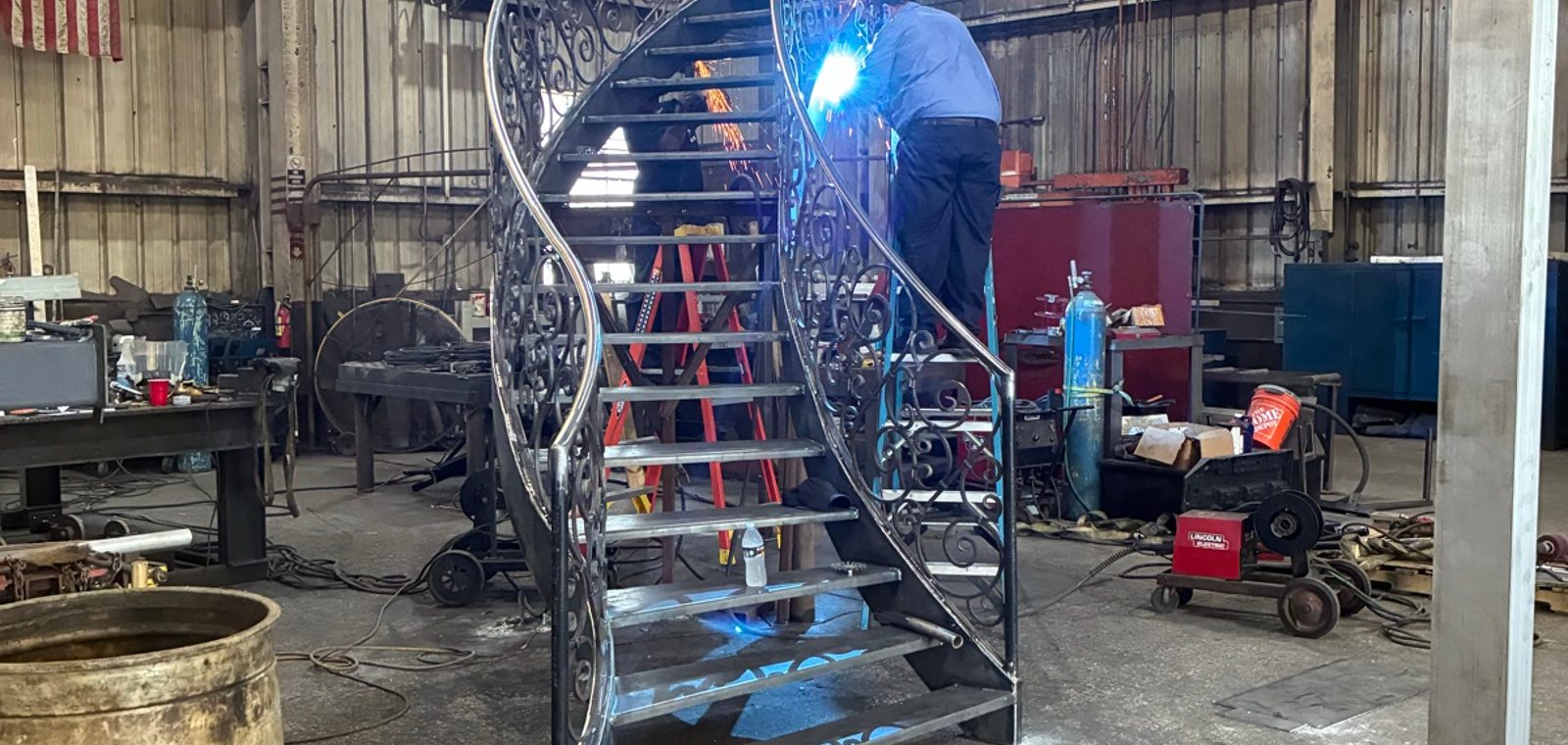 Bright welding arc with multiple structural members in jig - sparks + light — A&K Machine & Fabrication, Jacksonville FL