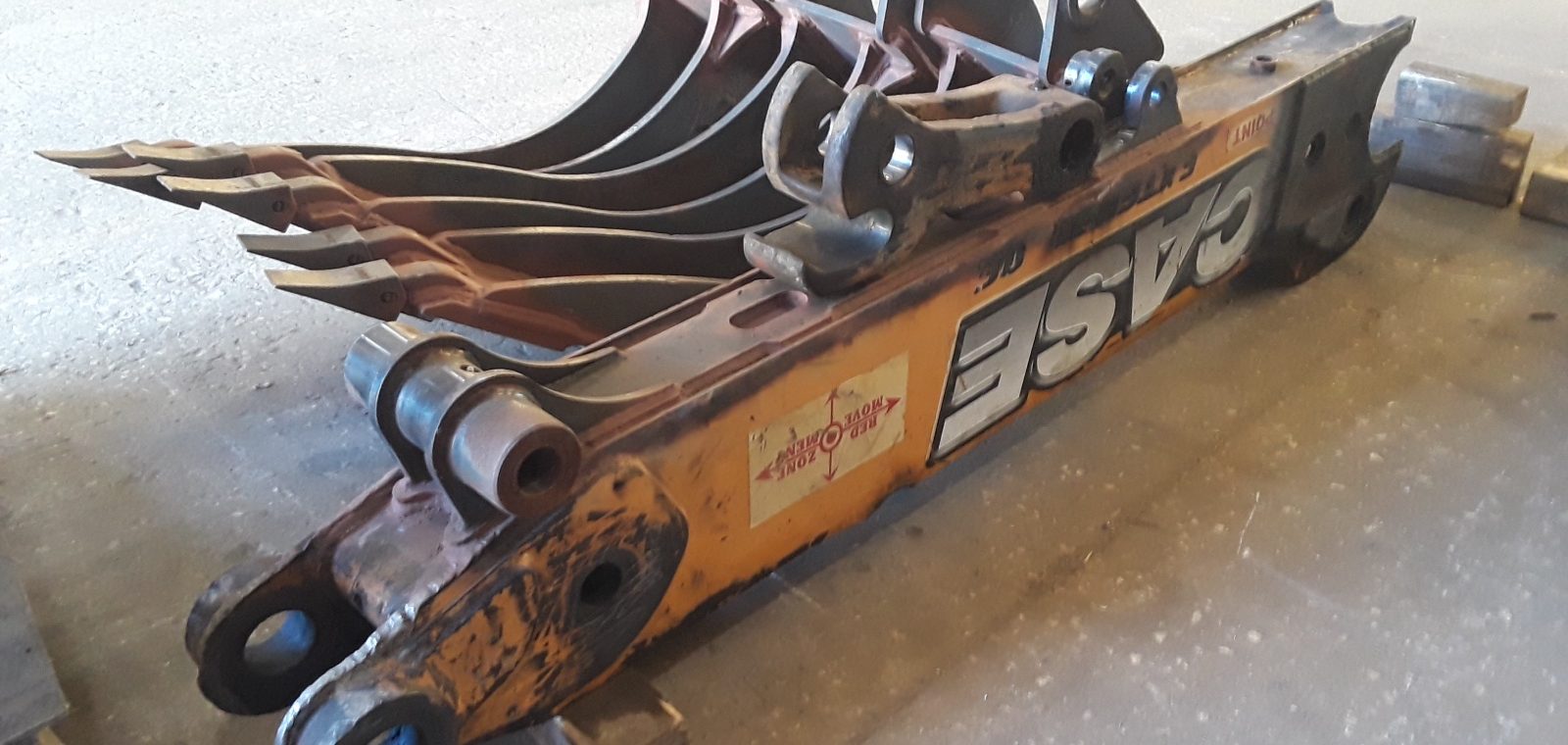 Row of bucket teeth (excavator/loader edge teeth) - recognizable — A&K Machine & Fabrication, Jacksonville FL