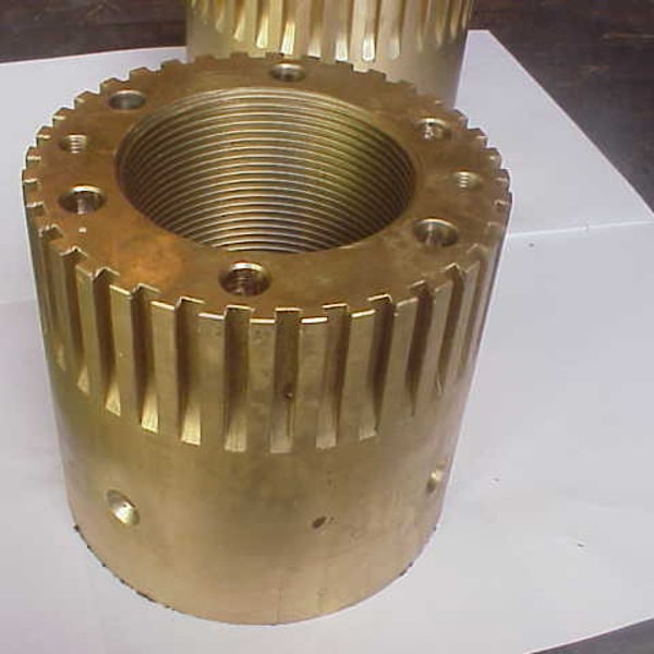 Large CNC-machined bronze gear with cut teeth and central bore