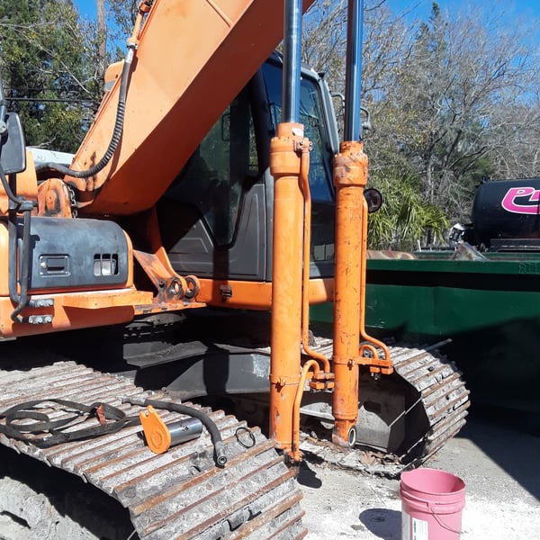 A&K technician servicing equipment outdoors with hydraulic torque tools