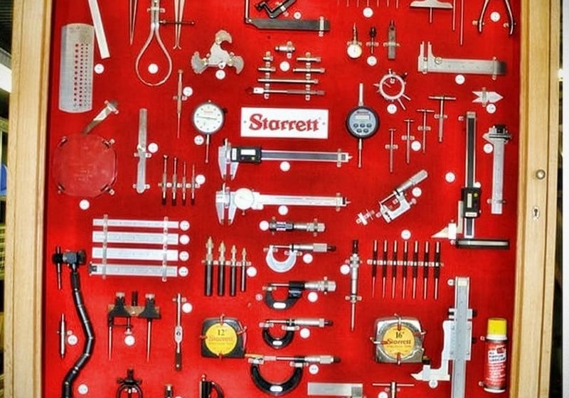 Starrett precision measurement tools on red display board at A&K Machine & Fabrication shop