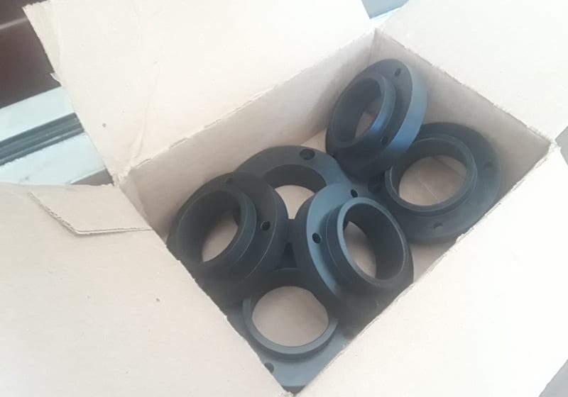 Stack of black rubber/poly molded rings in box — A&K Machine & Fabrication, Jacksonville FL