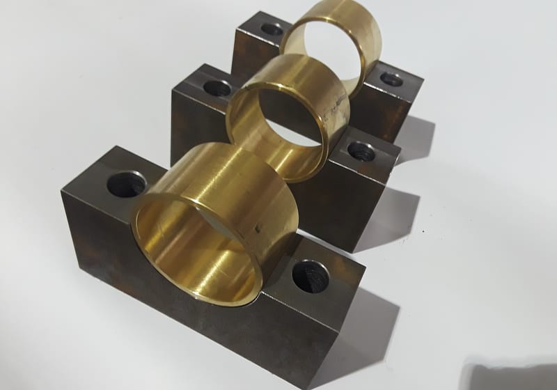Black steel mount with brass bushing - assembled fixture — A&K Machine & Fabrication, Jacksonville FL