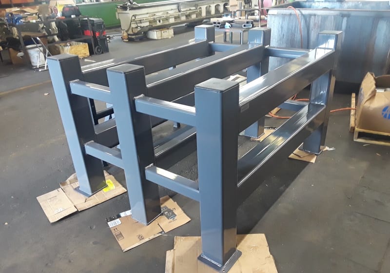 Large blue painted fabricated frame on workshop floor — A&K Machine & Fabrication, Jacksonville FL