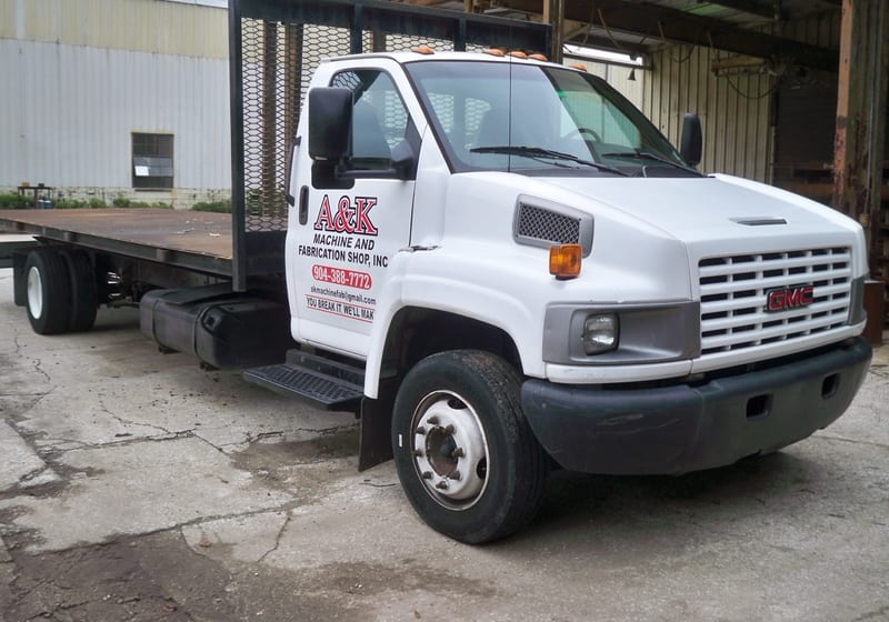 A&K branded delivery truck (white box truck) outside shop — A&K Machine & Fabrication, Jacksonville FL