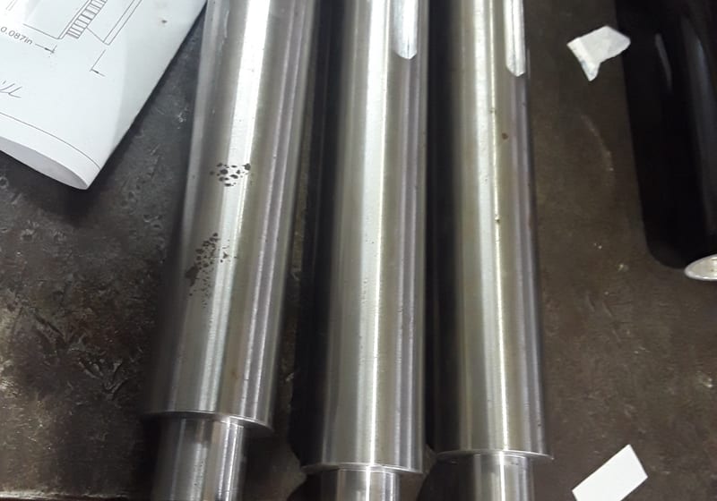 Row of machined hex-end shafts - clean precision turn — A&K Machine & Fabrication, Jacksonville FL