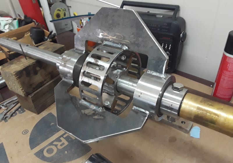 Long machined steel shaft assembly with brass coupling on lathe - heavy precision — A&K Machine & Fabrication, Jacksonville FL