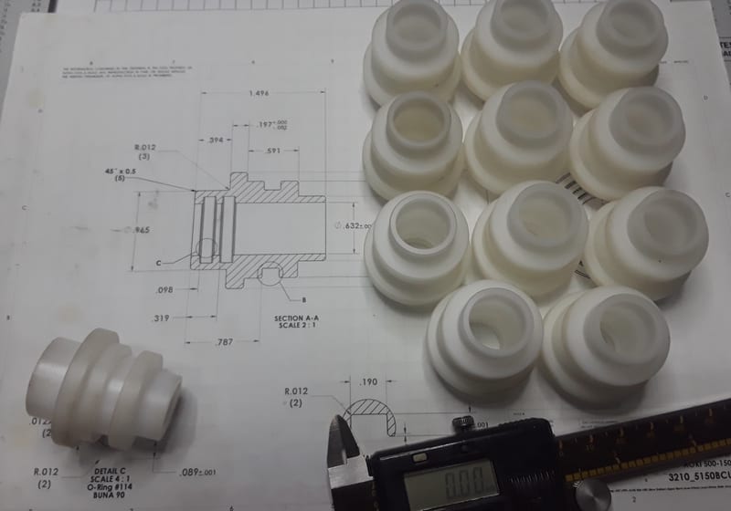 Poly bushings with calipers + drawing - QC inspection — A&K Machine & Fabrication, Jacksonville FL