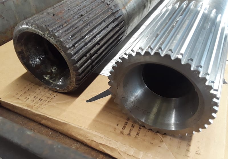 Close-up ribbed cylinders (heat exchanger? cooling fins?) — A&K Machine & Fabrication, Jacksonville FL
