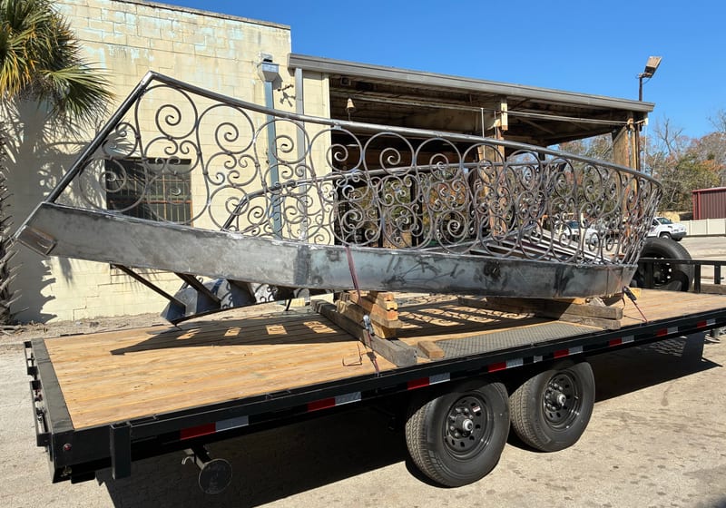 Spiral iron staircase loaded on flatbed trailer for delivery — A&K Machine & Fabrication, Jacksonville FL