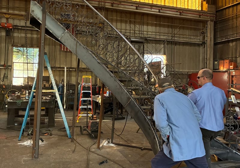 Spiral staircase fabrication, multiple workers visible — A&K Machine & Fabrication, Jacksonville FL