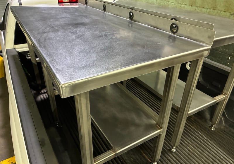 Stainless steel work table with backsplash and lower shelf - close-up of finished food-grade fabrication — A&K Machine & Fabrication, Jacksonville FL