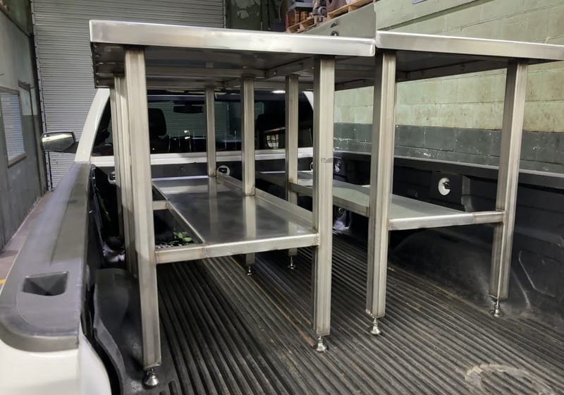 Stainless steel work tables loaded in pickup bed for delivery - multiple finished pieces — A&K Machine & Fabrication, Jacksonville FL