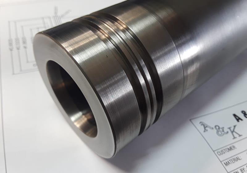 Machined steel cylinder with internal bore + slot - close-up of finished work — A&K Machine & Fabrication, Jacksonville FL