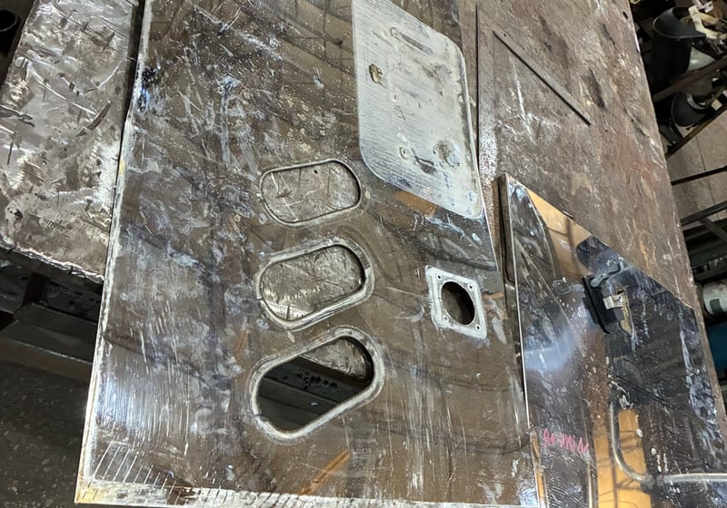 Large steel plate with three machined oval access cutouts and rectangular hatch - fresh waterjet/torch work — A&K Machine & Fabrication, Jacksonville FL