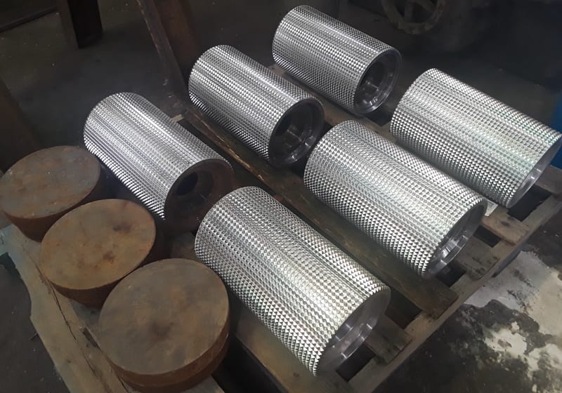 Tall stack of machined steel cylinders — A&K Machine & Fabrication, Jacksonville FL