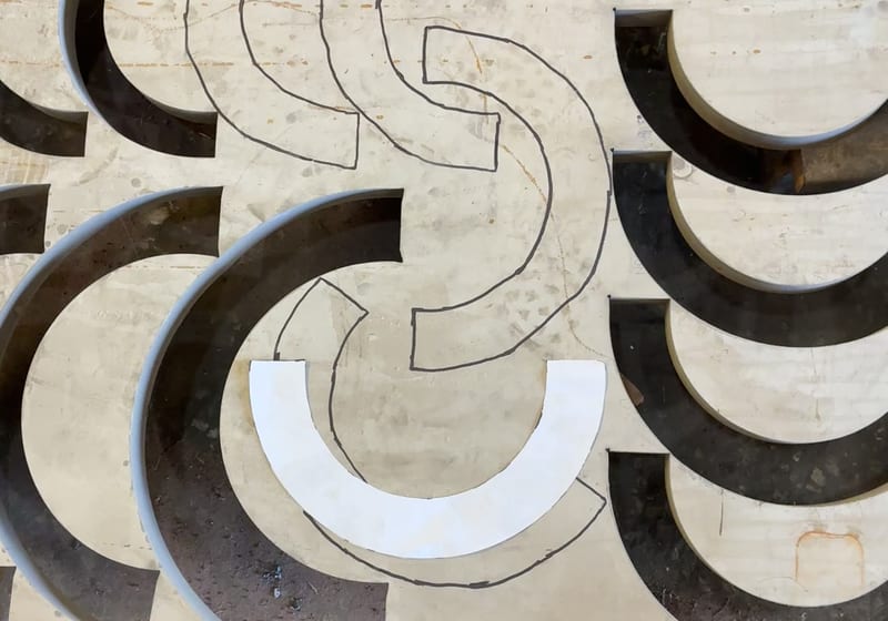 Waterjet cutting curved profile parts with kerf visible - machine in action — A&K Machine & Fabrication, Jacksonville FL