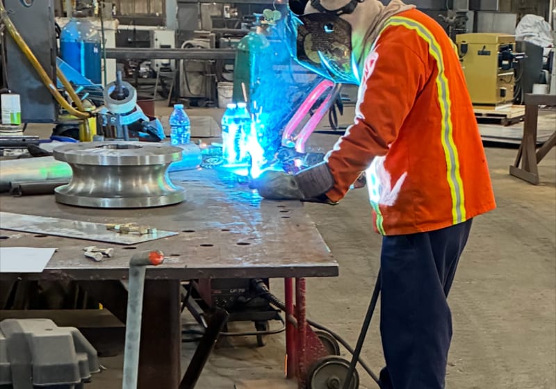 Welder working in shop under fluorescents - action — A&K Machine & Fabrication, Jacksonville FL