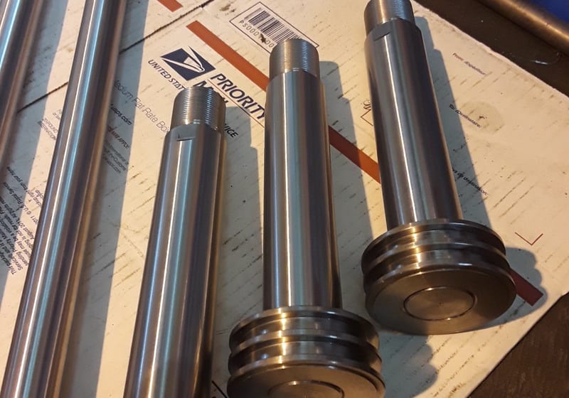 Several large machined wheels/sheaves on lathe table — A&K Machine & Fabrication, Jacksonville FL