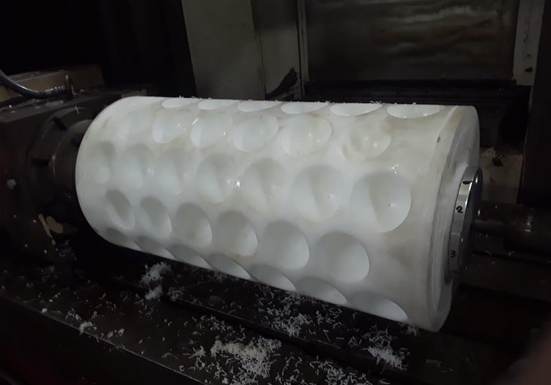 White poly machined cylinder with pocketed grid pattern — A&K Machine & Fabrication, Jacksonville FL
