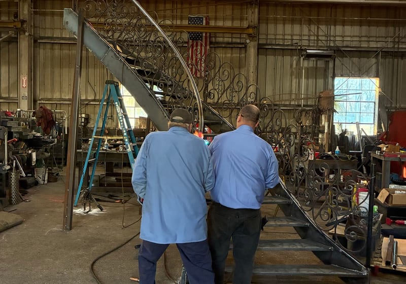 Worker on spiral staircase install — A&K Machine & Fabrication, Jacksonville FL