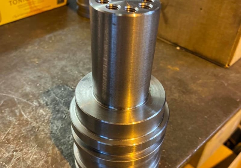 Precision-machined steel hydraulic cylinder body with stepped grooves at A&K Machine & Fabrication