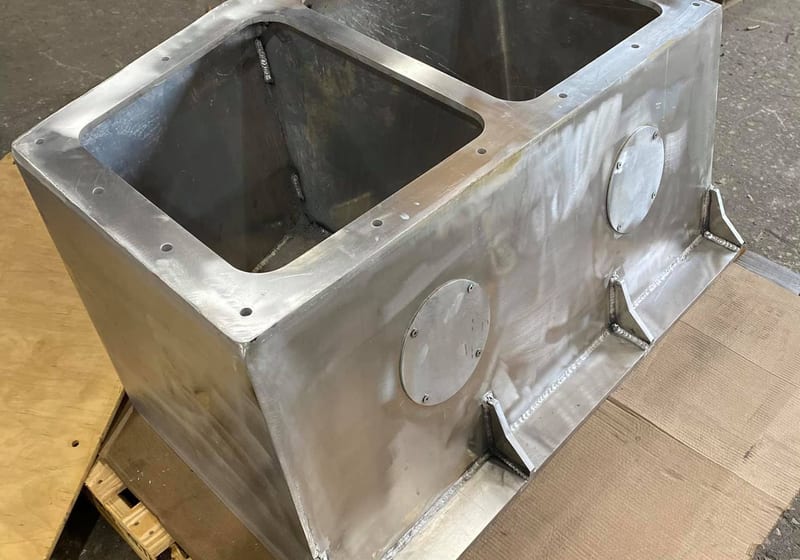Custom-fabricated aluminum boat transom box with inspection ports welded by A&K Machine & Fabrication