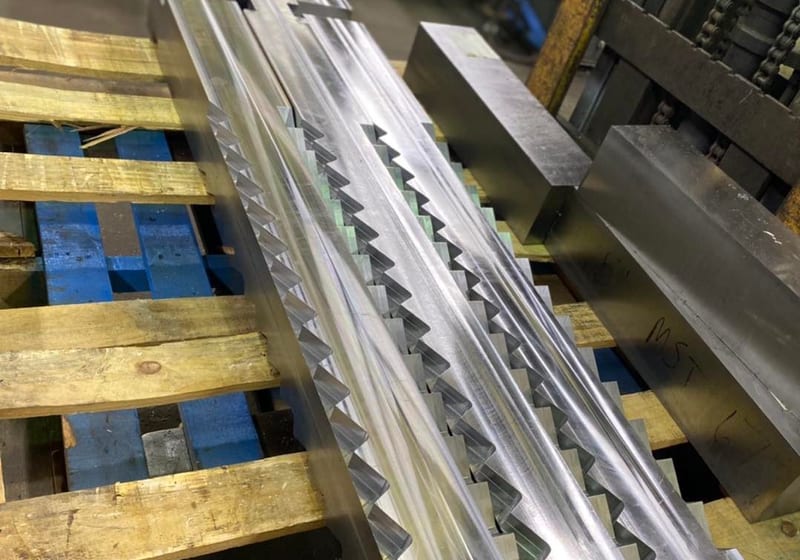 Precision-machined serrated aluminum concrete studs with zigzag profile at A&K Machine & Fabrication