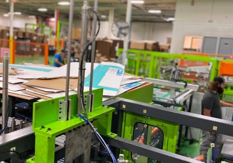 Custom slide rail sensor mount installed on production line machinery at A&K Machine & Fabrication