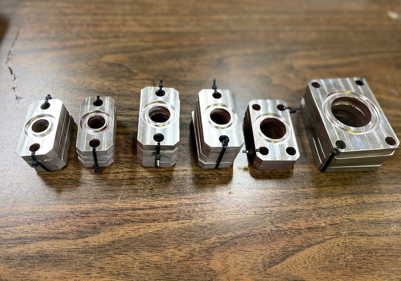 Set of six precision CNC-machined aluminum bearing housings in graduated sizes at A&K