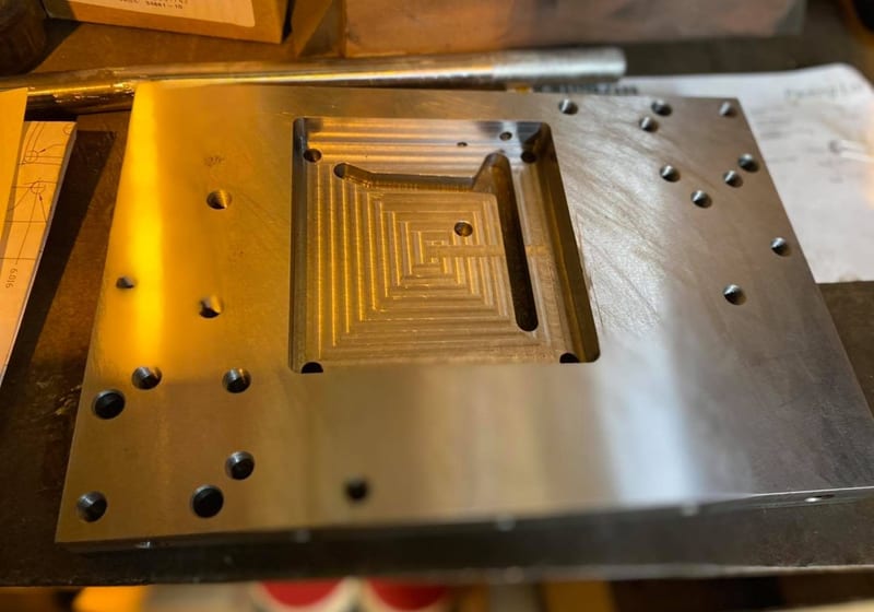 CNC-machined steel press die plate with pyramidal pocket cavity at A&K Machine & Fabrication