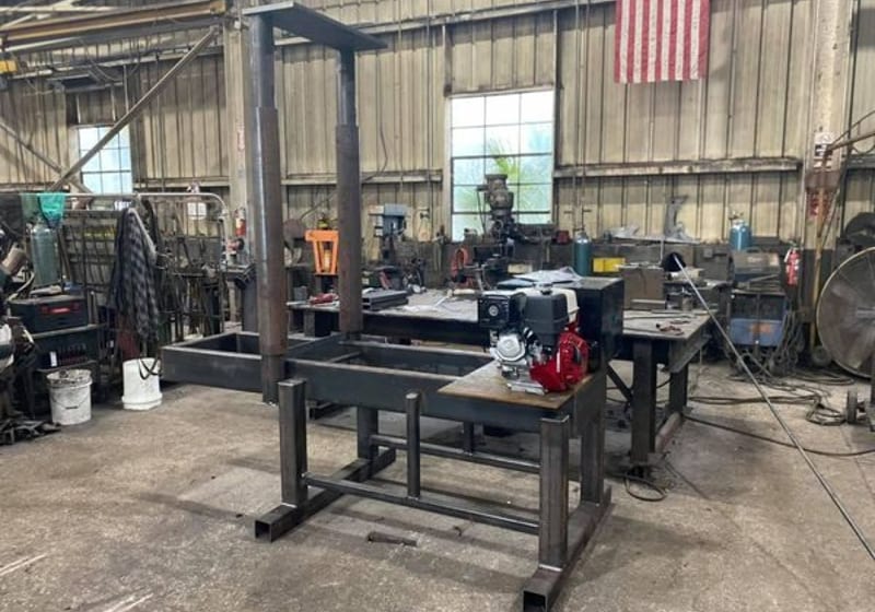 Heavy steel log splitter frame with vertical I-beam column at A&K Machine & Fabrication