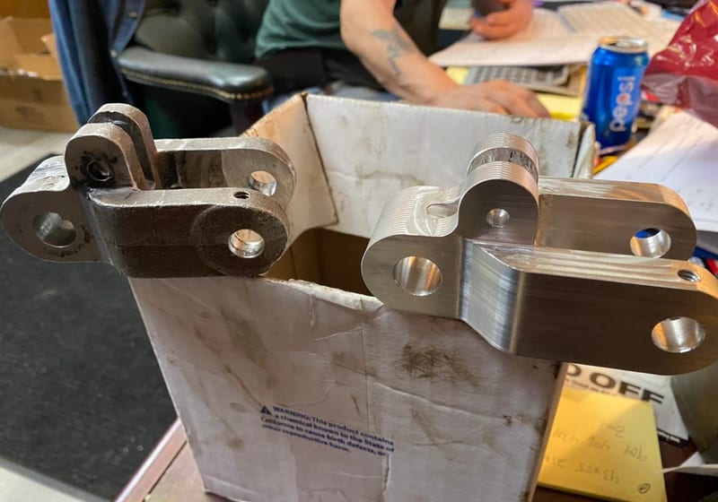 Worn original vs freshly CNC-machined aluminum USPS clevis block replacement at A&K