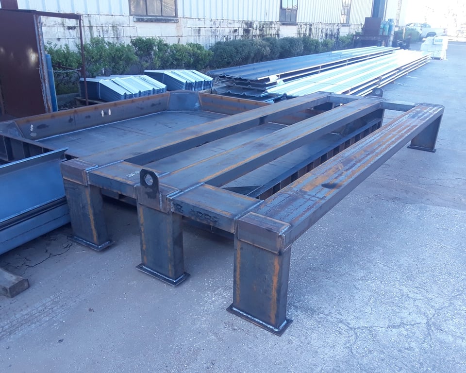 Heavy blue-painted fabricated steel frame in the A&K shop — A&K Machine & Fabrication, Jacksonville FL