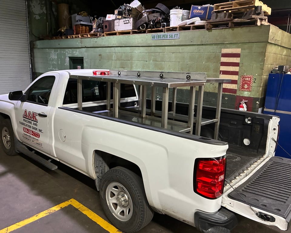 A&K branded white service pickup with custom welded ladder rack — service vehicle ready to deploy on-site — A&K Machine & Fabrication, Jacksonville FL