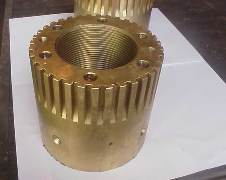 Large bronze gear sitting on shop floor — A&K Machine & Fabrication, Jacksonville FL