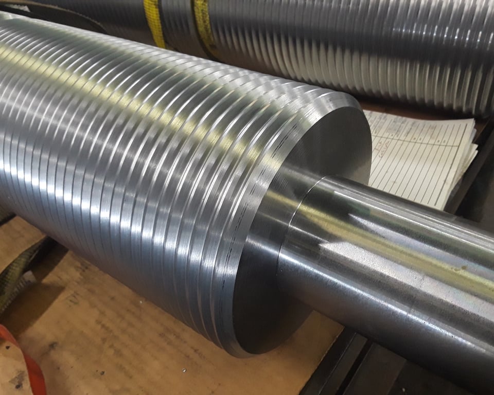 Close-up of a CNC-machined steel shaft showing knurling and precision threads — A&K Machine & Fabrication, Jacksonville FL